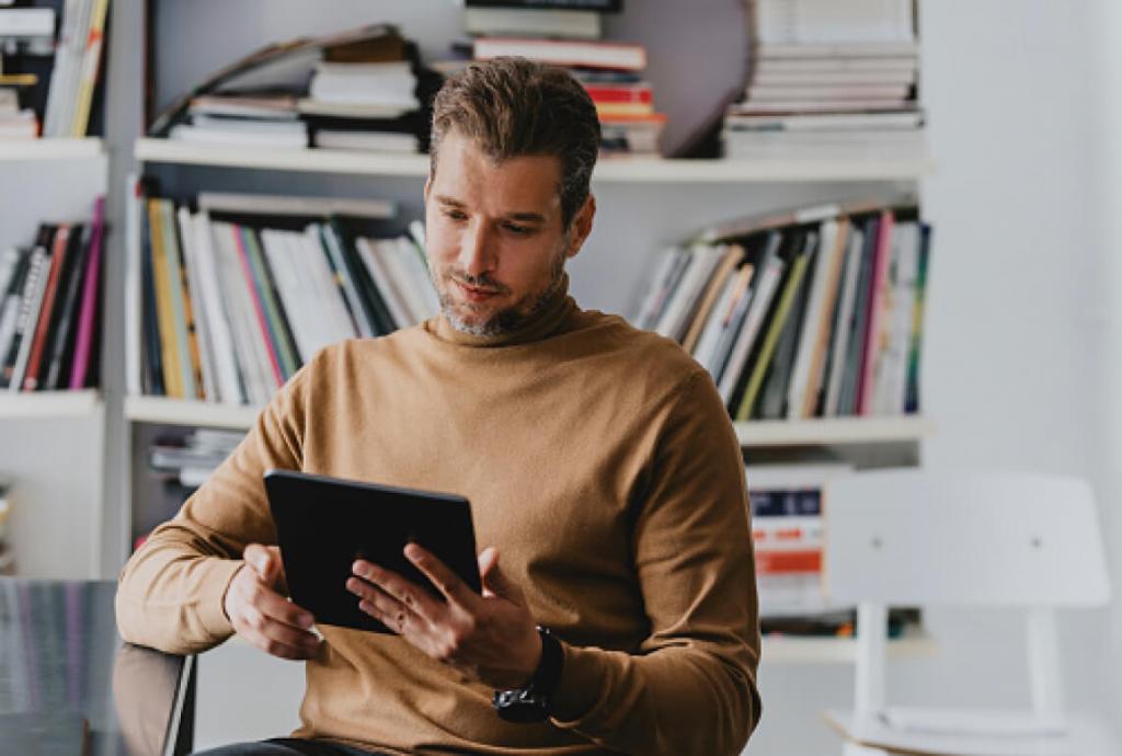 man at home, looking at his tablet